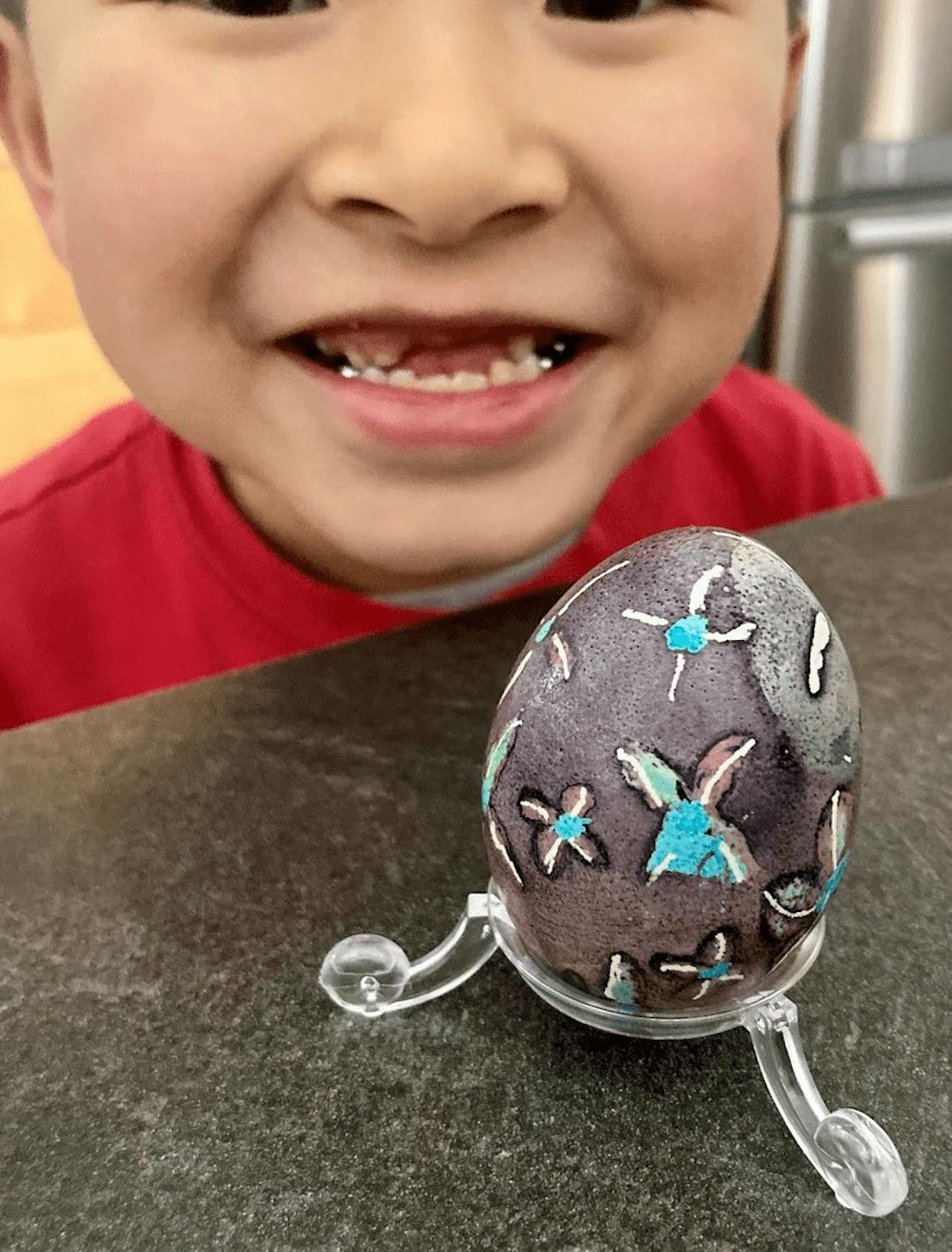 Elam, 7 years old, made his first attempt in painting and waxing a pysanky egg, hoping for love and peace in this world. 