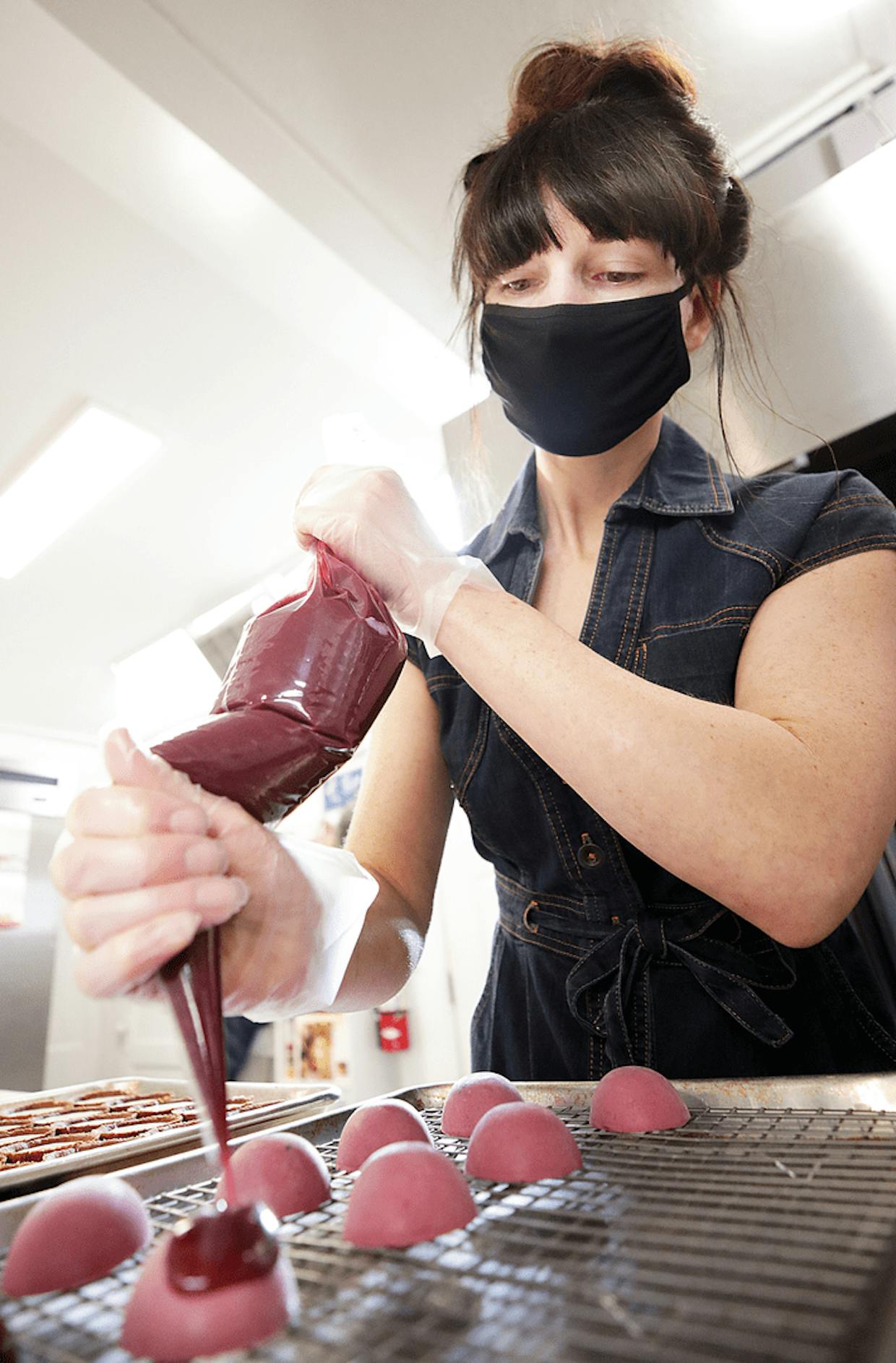 Pastry chef and Patisserie Jacqui owner Jackie Oatman creates a batch of blackberry mousse tarts in preparation for Valentine’s Day in Bisbee.