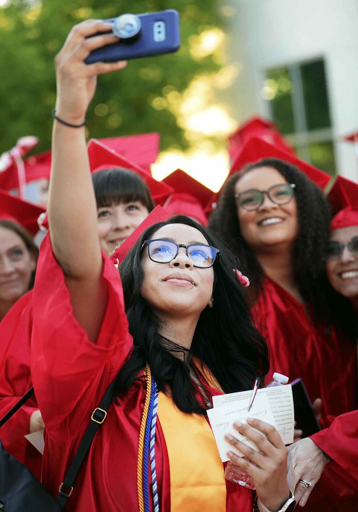 Alma Chavez captures the moment with fellow graduates Friday evening.
