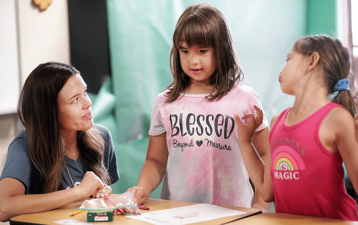 Pueblo del Sol Elementary School teacher Ashley Breen chats with first graders Madison Ciezki and Celerina Carrillo, right, yesterday during SVUSD's Summer Academy.