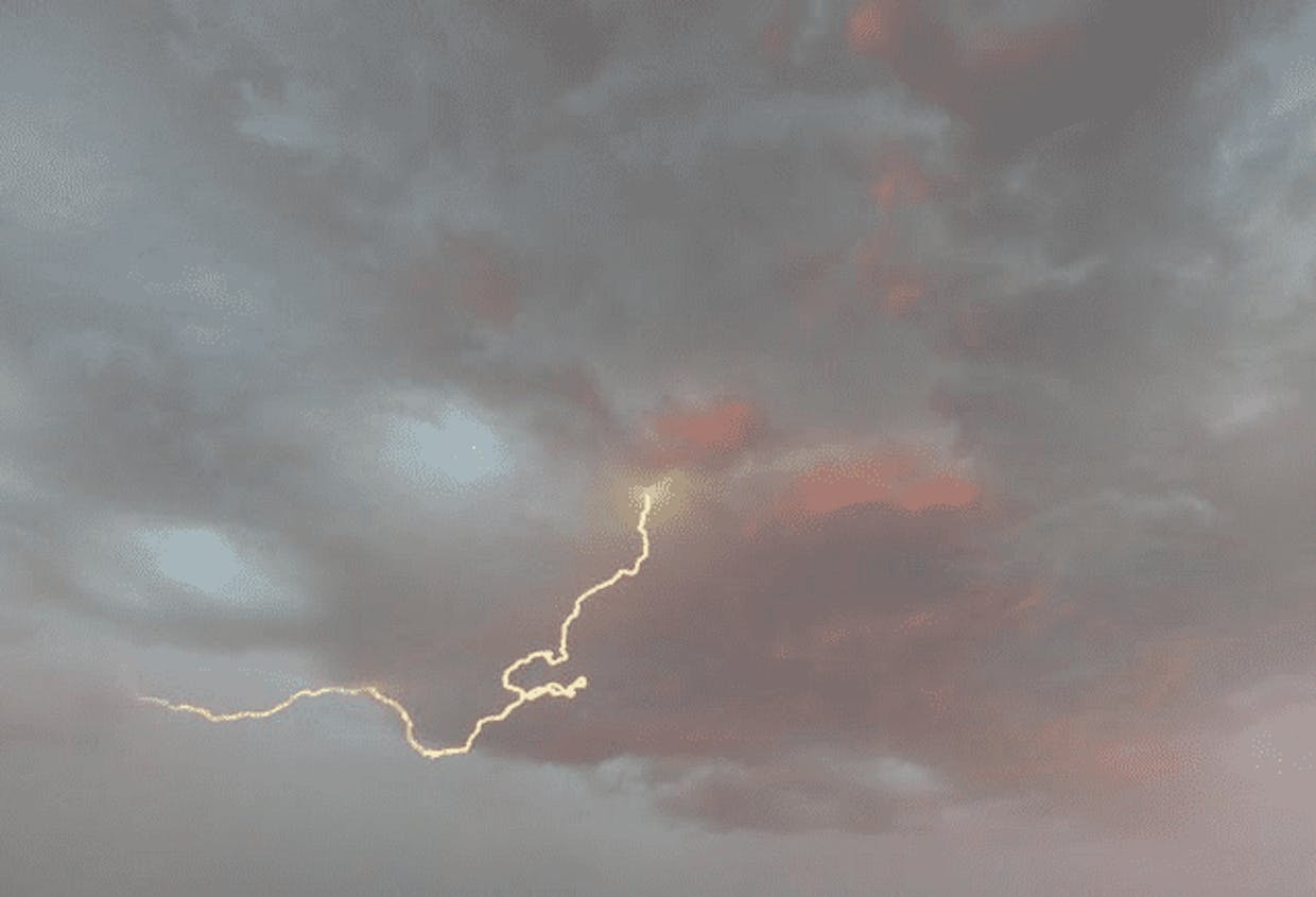  Lightning streams from a cloud during a recent monsoon storm.