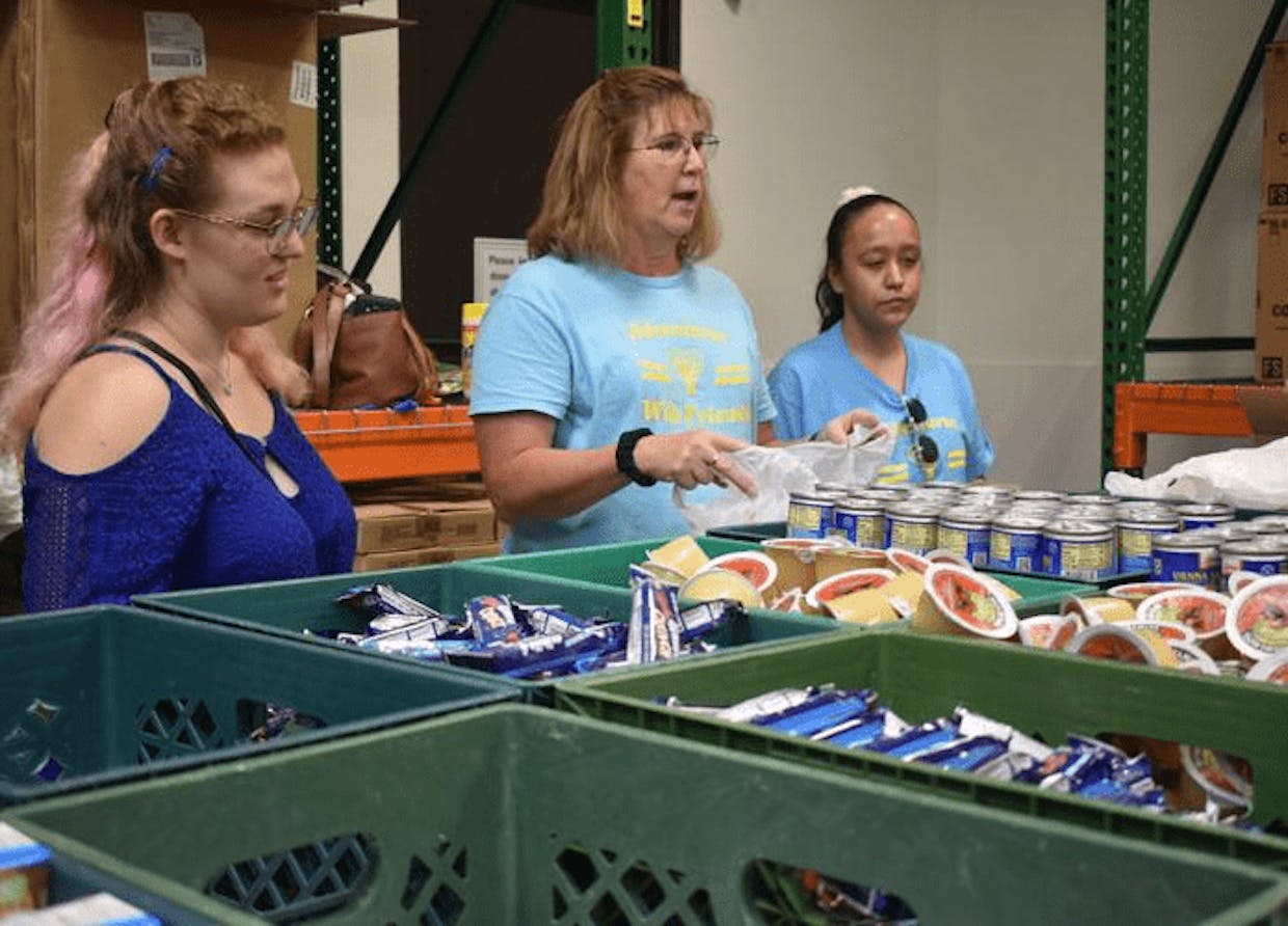 Penny Grabowski works alongside members Arianna Mabry and Melissa Egurrola. (Jamie Verwys)