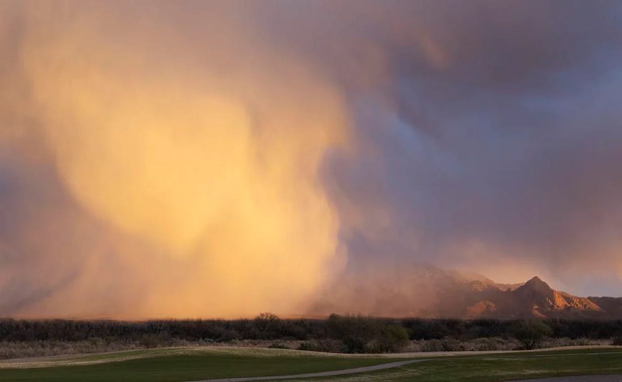 A snow cloud forms near the Santa Rita Mountains on Monday evening. (Michael O'Brien)