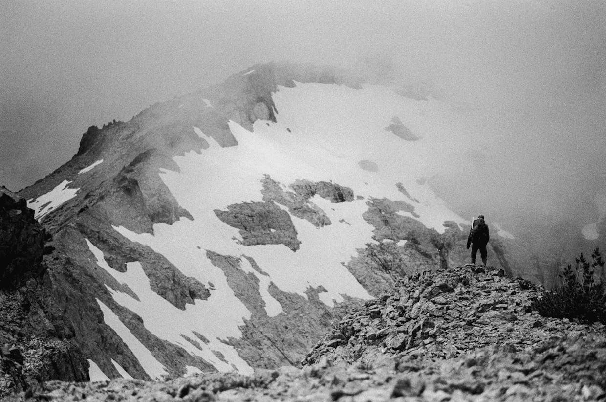 Cody Cottier peers off at Mt. Daniel during a scramble up the left ridge of the mountain, July 21.